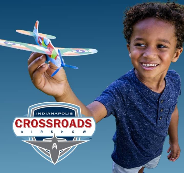 Child holding toy airplane.
